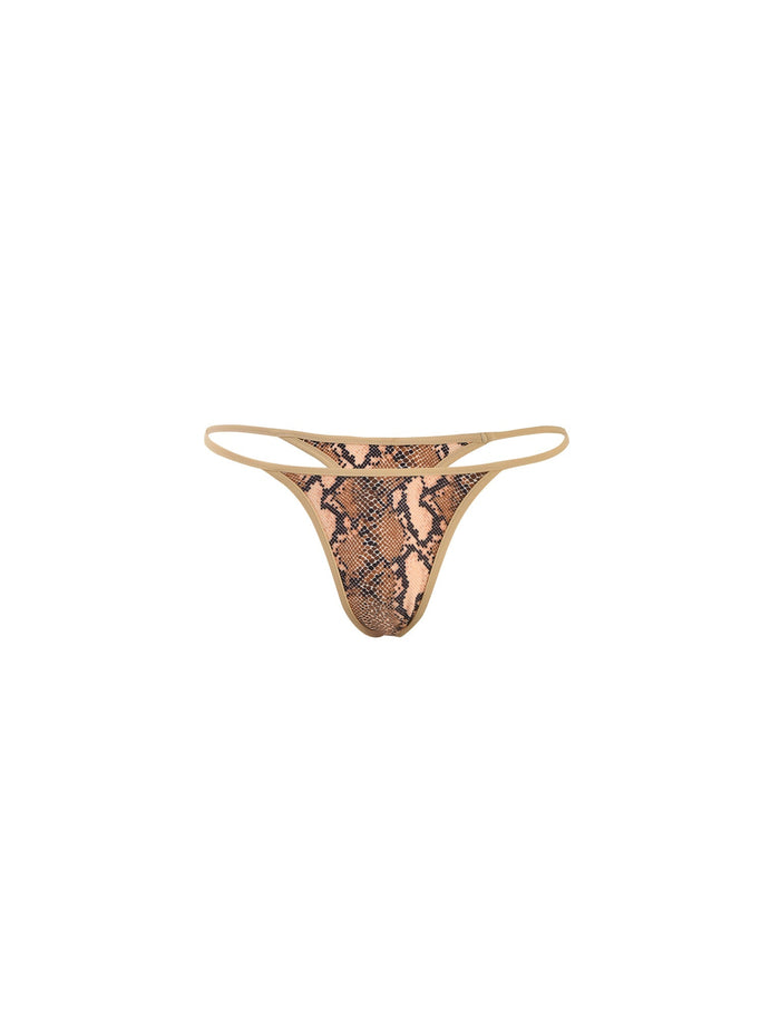A pair of women's LULA BIKINI BOTTOM - BROWN: SNAKE underwear from TIGERMIST with a beige and black snakeskin pattern. The bikini bottom features a minimalistic design with thin side straps and a low-rise cut. The background is white.