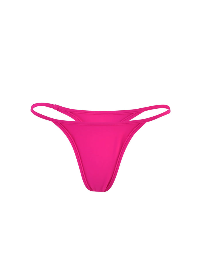 A front-facing view of the LULA BIKINI BOTTOM - PINK : HOT PINK from TIGERMIST. The minimalistic design features thin side straps and a smooth, seamless front panel. The vibrant hot pink color stands out, making it a bold swimwear choice.