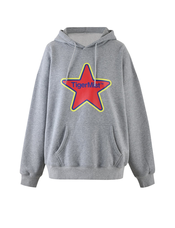 The LUMEN HOODIE - GREY by TIGERMIST features a large red star graphic with a yellow outline and the text "Tiger Mist" in blue across the star. This stylish gray hoodie includes a front pocket and an adjustable drawstring at the neck.