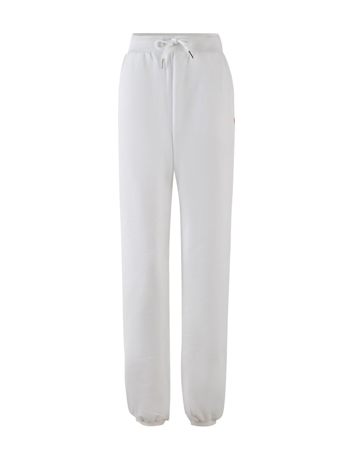 The LUMEN PANT in white by TIGERMIST is a pair of mid-rise loungewear pants featuring an elastic waistband and drawstring tie. These sweatpants offer a relaxed fit with tapered legs and elastic cuffs at the ankles, creating an oversized trackpant silhouette. They also include subtle seam pockets on each side.