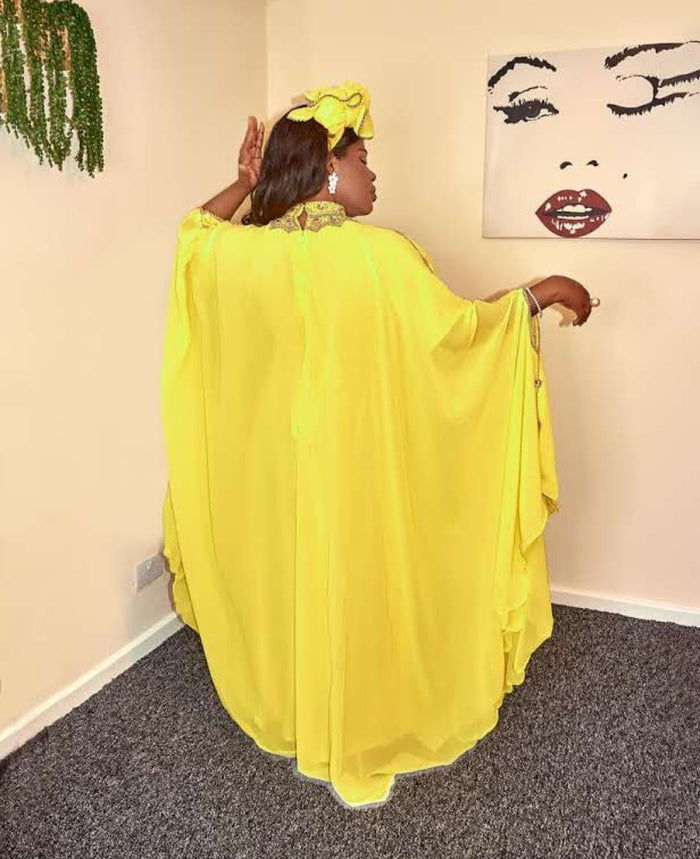 Back view of yellow flowing kaftan abaya with wide sleeves and soft drape design
