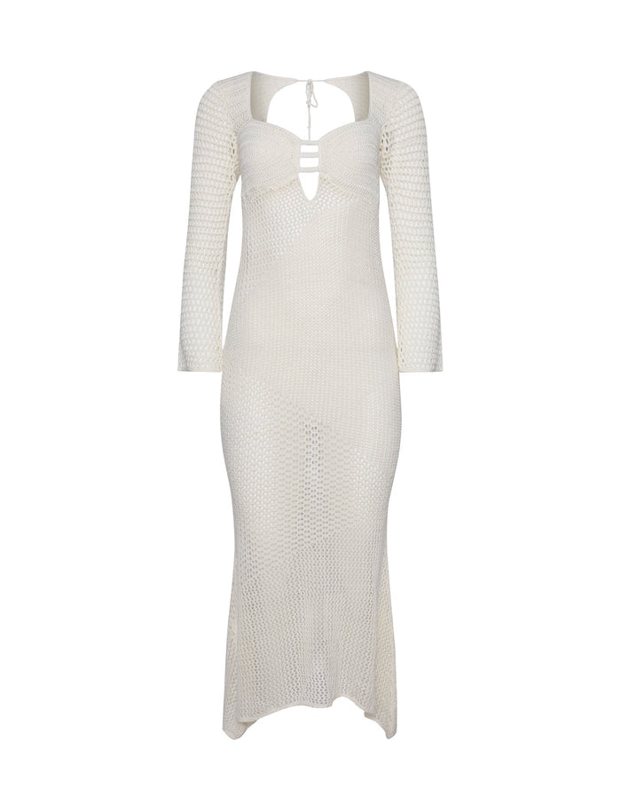 The MACAULEY DRESS - WHITE : CREAM by TIGERMIST is a white, long-sleeved, ankle-length knit dress with a form-fitting silhouette. It features a cut-out design at the neckline with two horizontal straps and a tie-up detail at the back of the neck. The semi-sheer material showcases an intricate geometric pattern.