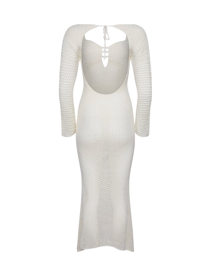 The MACAULEY DRESS - WHITE : CREAM from TIGERMIST showcases a form-fitting silhouette and features a distinctive open back design with a tie closure. A cut-out detail near the shoulder blades adds flair, complemented by its soft A-line shape that ends in a mid-calf length hem.