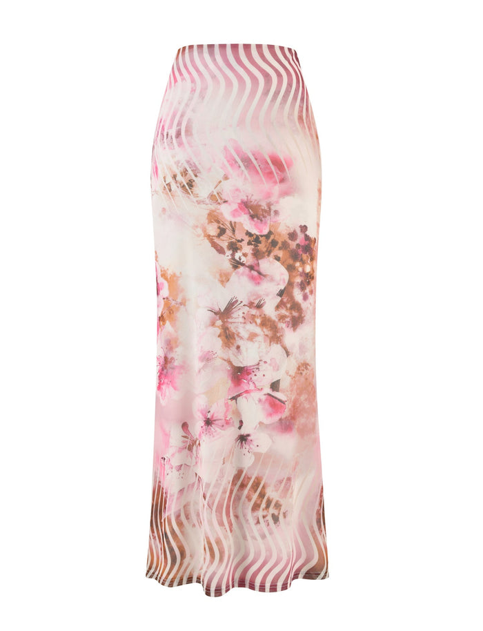 Introducing the MACEY SKIRT - MULTI : FLORAL from TIGERMIST—a stunning high-waisted, long skirt featuring a vibrant floral pattern in shades of pink, peach, and white. The design incorporates abstract wave-like lines that add texture to the garment. The skirt is tailored to fit snugly at the top and gently flares towards the bottom, resulting in a sleek and flowing silhouette.