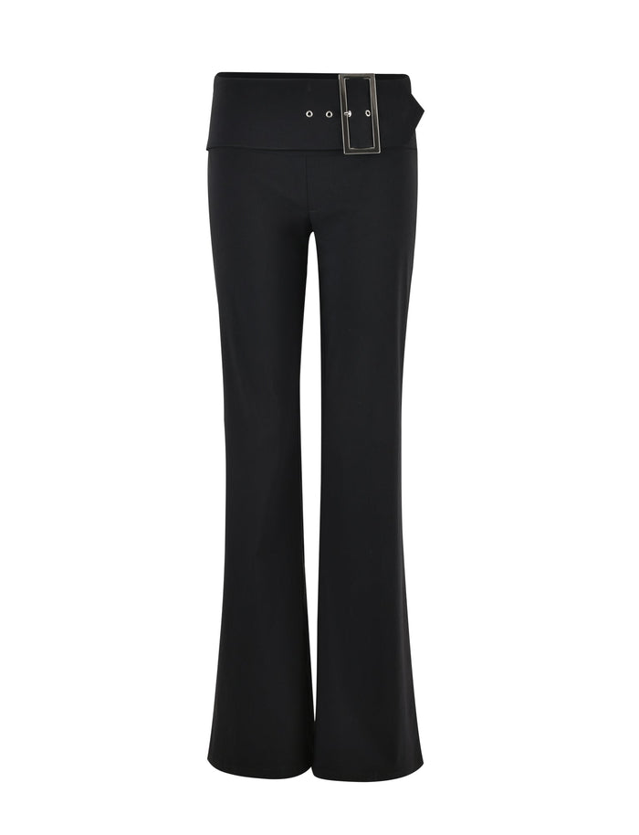 Image of the MERRI PANT - BLACK by TIGERMIST. These black flared pants feature a wide waistband with an oversized rectangular metal buckle, and two eyelets on the left side where the buckle attaches. The sleek design is crafted without visible pockets or additional embellishments.
