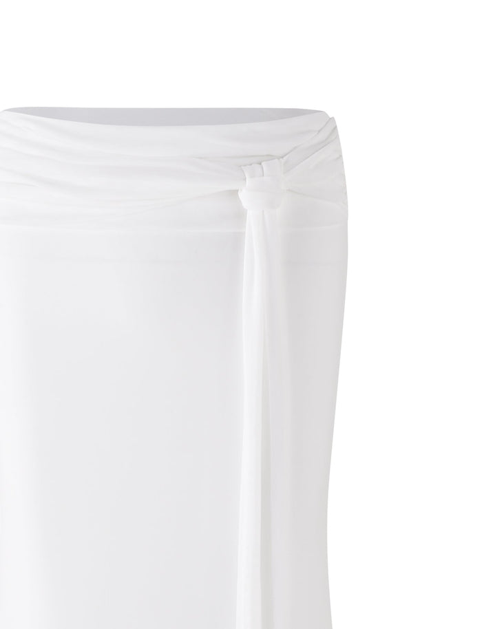 A close-up of the white fabric from the TIGERMIST MIST SKIRT, featuring a knot tied at the waist. The soft and lightweight material drapes smoothly from the knot, set against a plain white background to highlight both the fabric and detailed knot.