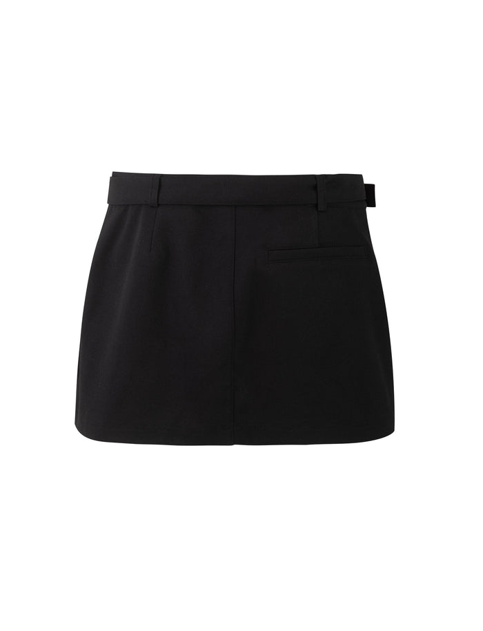 Introducing the NADINE SKORT - BLACK by TIGERMIST. This black mini skort boasts a tailored fit and features a subtle waistband with belt loops, a single welt pocket on the right side, and a smooth, polished finish. The hemline rests above the knee.