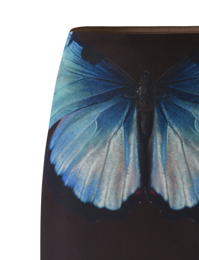 A close-up view of the NANCI SKIRT - BROWN : BUTTERFLY from TIGERMIST showcases a realistic print of a large blue butterfly with black-edged wings. The vivid and intricate colors and details of the butterfly are set against a dark background.