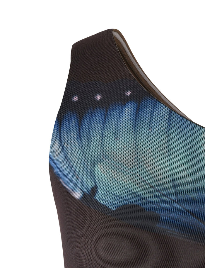 Close-up of a brown sleeveless NANCI TOP - BUTTERFLY from TIGERMIST, adorned with delicate butterfly patterns, giving it an elegant and ethereal look. The image captures the upper section of the top, showcasing the vivid detail of the butterfly design.
