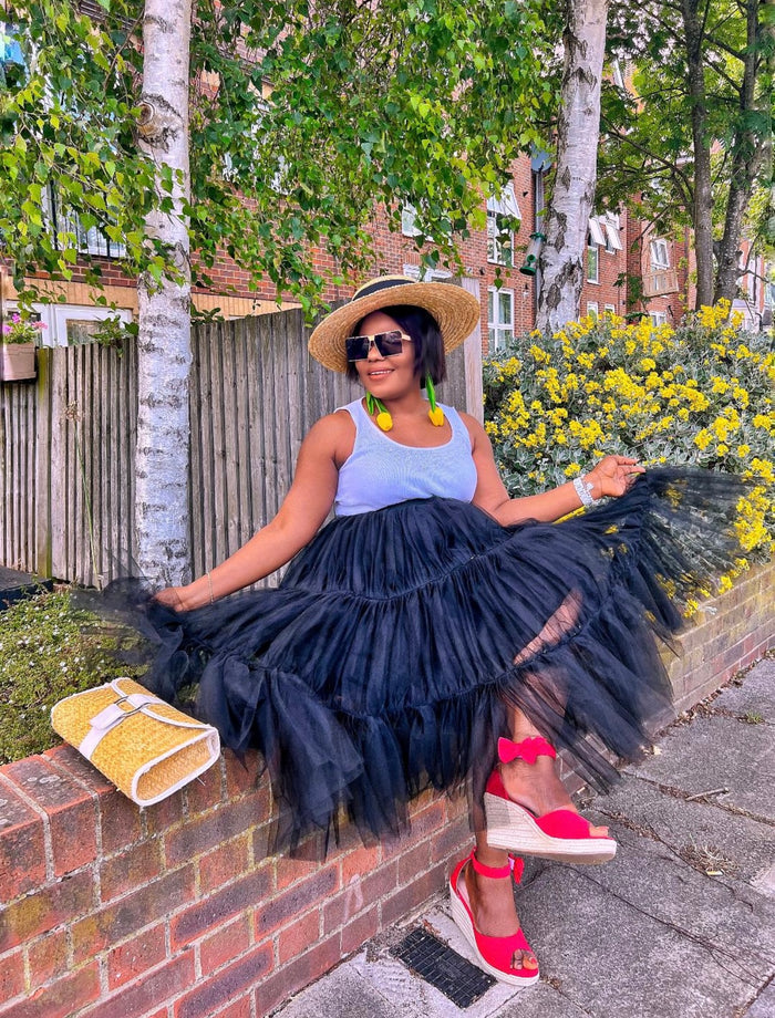 Black swing tiered tulle skirt styled casually with tank top and summer accessories
