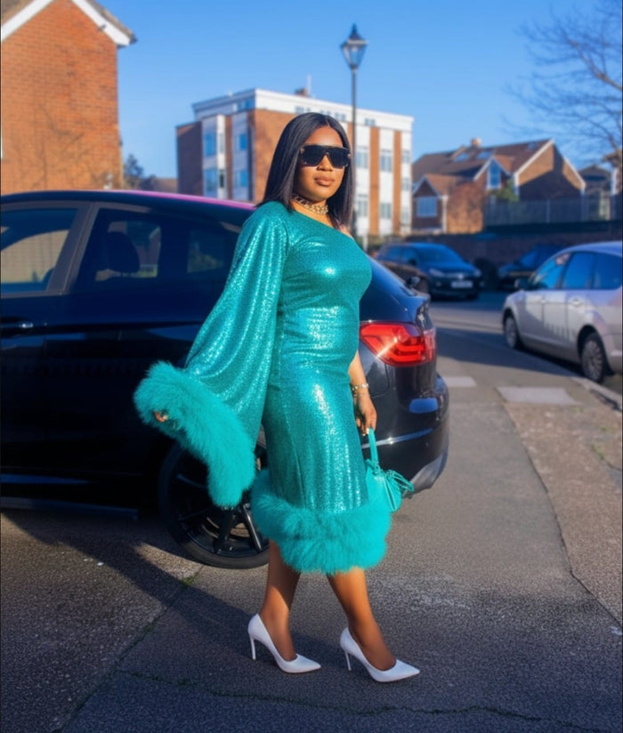 Woman wearing green one shoulder sequin dress with fur trim elegant party dress