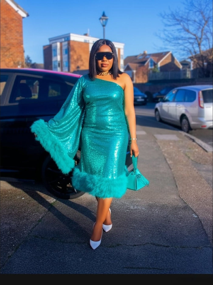 Woman in a teal dress with feather trim