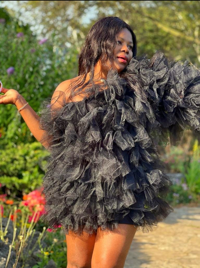 woman wearing a stylish extra lush tulle dress in the garden