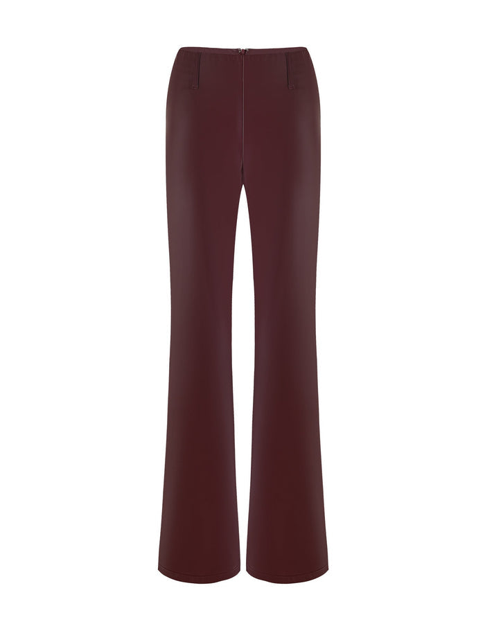 The PU TEDDIE PANT - RED in Cherry Red from TIGERMIST is a pair of high-waisted pants with a slightly flared leg. They have a smooth finish and feature a zipper closure at the front.