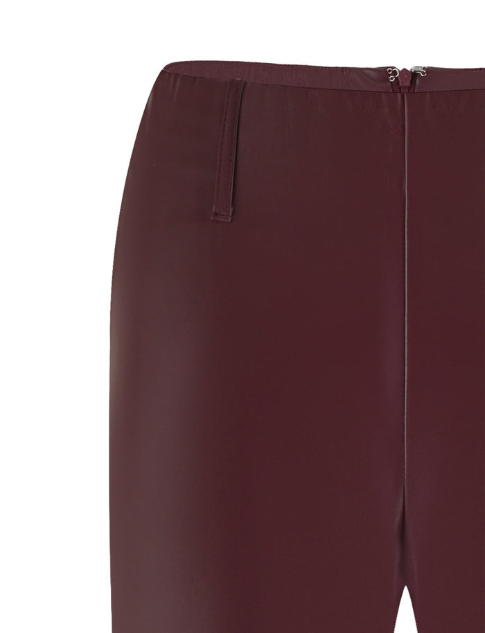 Close-up of the waist area of the Cherry Red PU Teddie Pant from Tigermist, showing the zipper at the back. The smooth texture of the leather-like material is prominent, displaying a sleek and polished appearance. Two small belt loops are visible at each side of the waist.