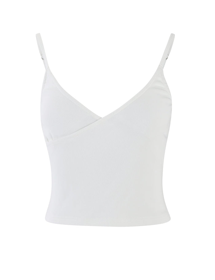 A white REY TOP from TIGERMIST featuring thin adjustable straps and a wrapped V-neckline design. This sleeveless tank top is plain and unadorned, creating a clean and simple look. The fabric appears to be lightweight and slightly stretchy.
