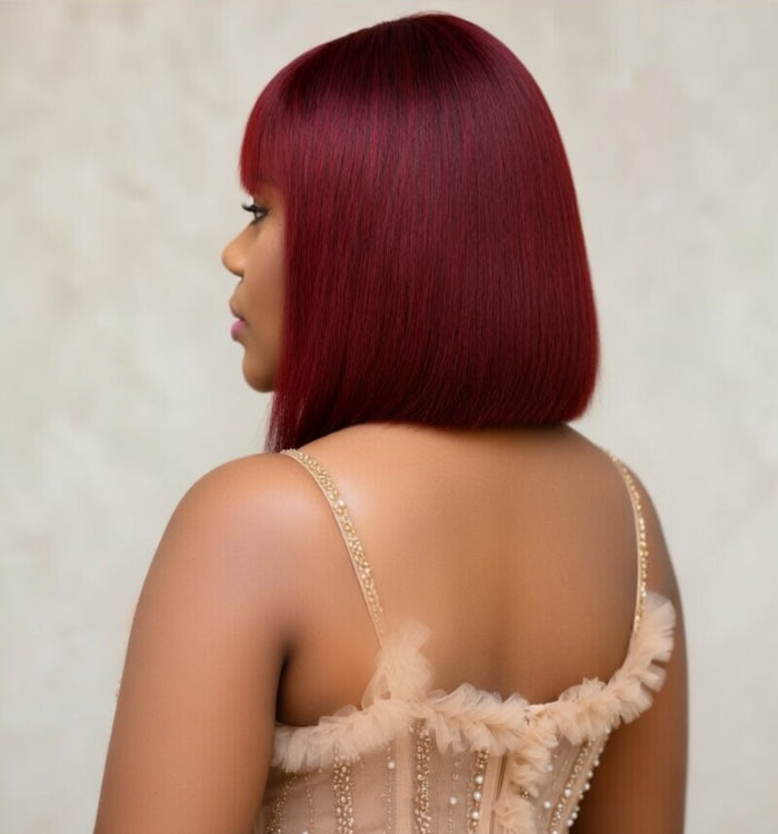 Woman wearing a deep red human hair blunt cut wig