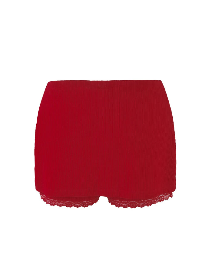 A pair of vibrant red TIGERMIST Sabine Skorts in Berry Red, featuring a textured fabric and delicate lace trim along the hem. The lace enhances the bottom edge, giving a stylish and slightly feminine touch. The skorts are displayed against a plain, white background.