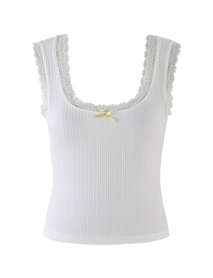 Introducing the SABINE TOP - WHITE by TIGERMIST: A sophisticated sleeveless white ribbed tank top, beautifully accentuated with lace trim around the scoop neckline and shoulders. Below the neckline, a delicate light yellow ribbon bow adds a touch of charm. The vertically ribbed fabric texture enhances its subtle elegance.