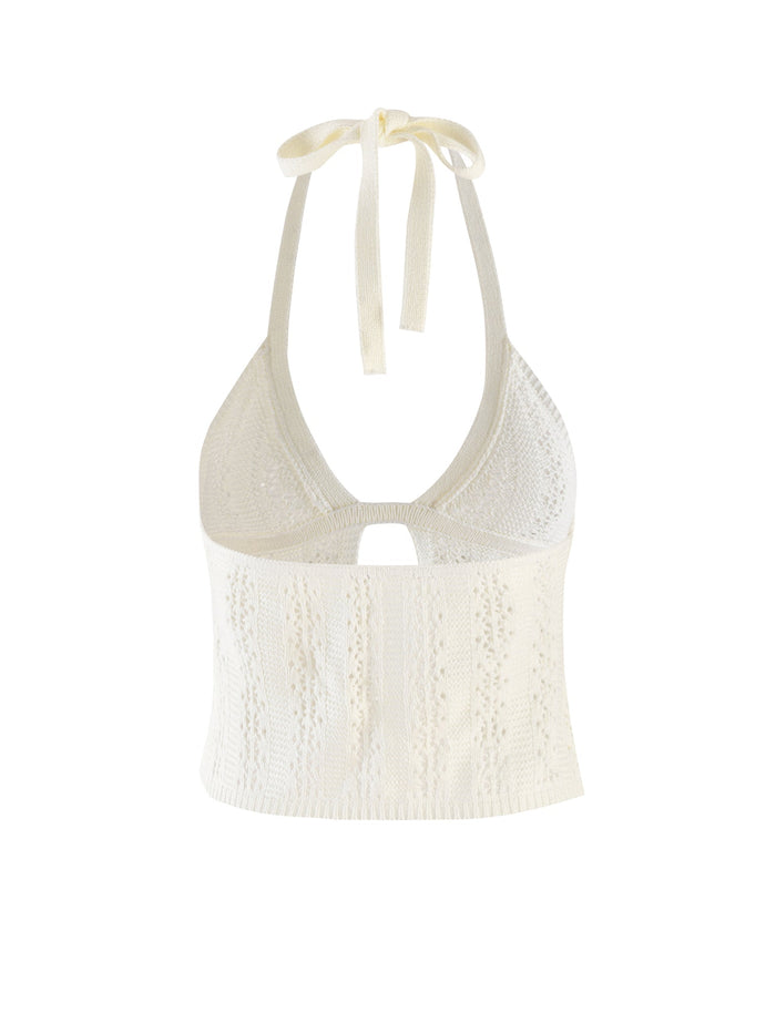 The SANDOR TOP - WHITE from TIGERMIST is a captivating halter crop top that features an intricate knitted pattern. This stylish piece includes a keyhole cutout beneath the bust and ties elegantly behind the neck, making it a unique addition to any wardrobe.