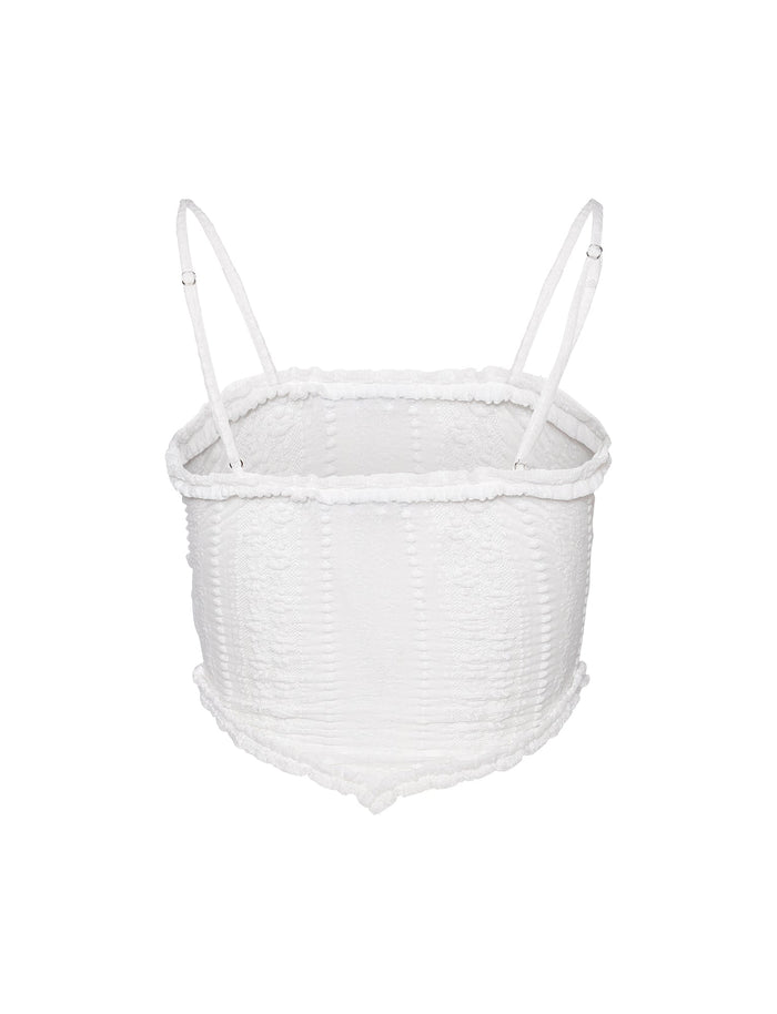 Introducing the SOPHA TWO PIECE TOP in white from TIGERMIST, a textured smocked crop top with spaghetti straps. It features a square neckline and elasticated detailing throughout for a stretchy fit, complemented by a slightly ruffled hem that adds a casual and stylish touch. Photographed against a plain white background.