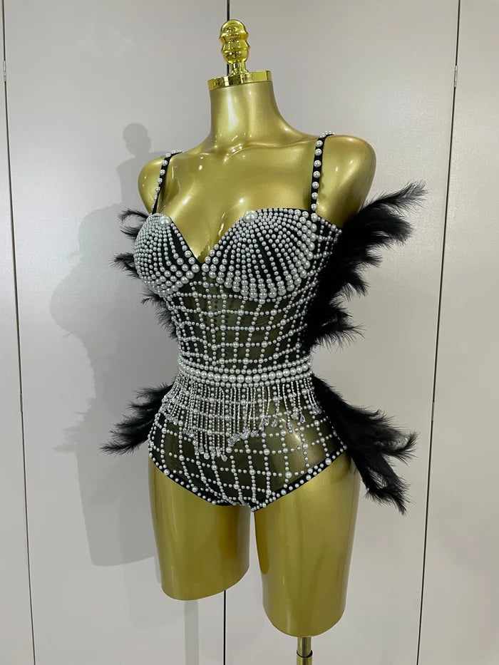 Shine in the Tabitha pearl, rhinestone, and feather mesh bodysuit. Luxury stretch outfit for stage performances, parties, and special events.