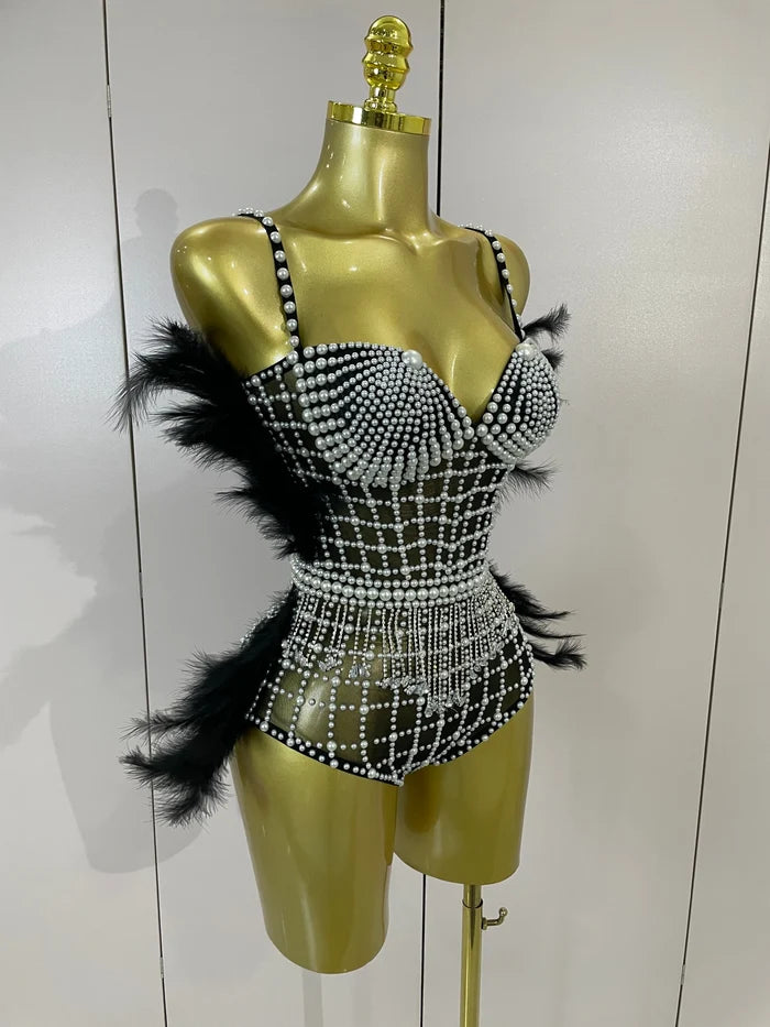 Shine in the Tabitha pearl, rhinestone, and feather mesh bodysuit. Luxury stretch outfit for stage performances, parties, and special events.