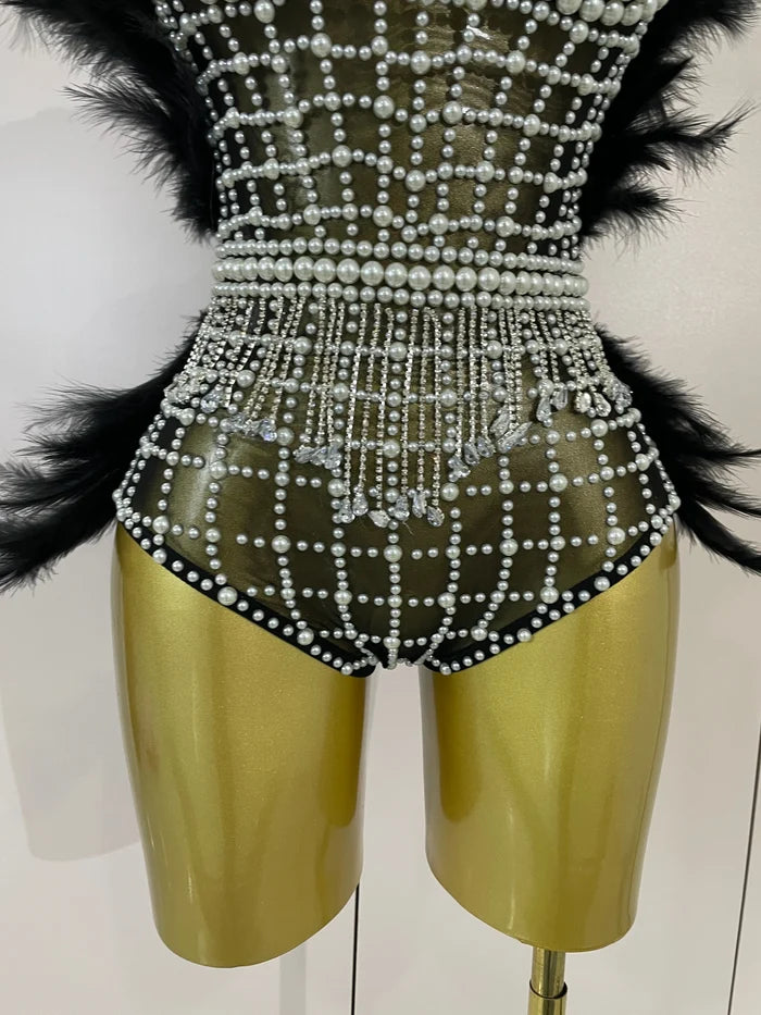Shine in the Tabitha pearl, rhinestone, and feather mesh bodysuit. Luxury stretch outfit for stage performances, parties, and special events.
