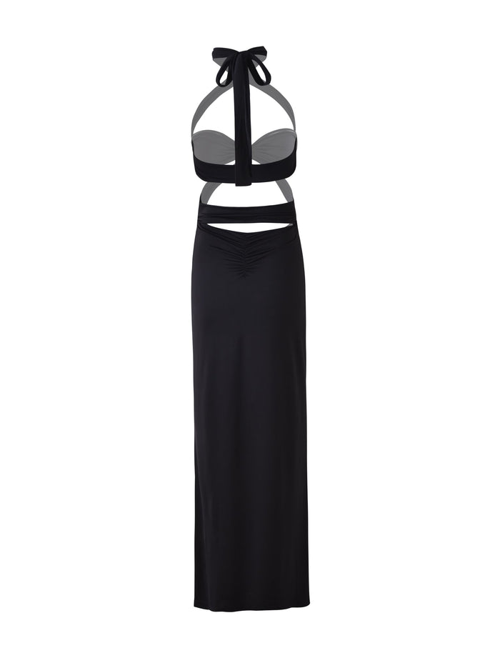 Introducing the TAMSIN MAXI DRESS - BLACK from TIGERMIST, a sleek black sleeveless halter-neck creation featuring cut-out sections at the waist and a fitted long skirt. The minimalist design is completed with a tied bow at the neck, exuding modern elegance.