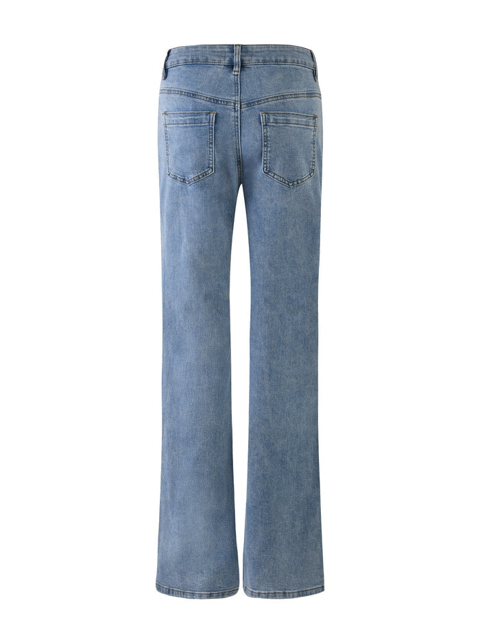 A back view of the TATYANA JEANS in Light Blue from TIGERMIST. These full-length, high-waisted jeans feature a straight-leg design with two back pockets that have intricate stitching details. The light wash denim fabric has a slightly faded appearance, giving it a vintage look.