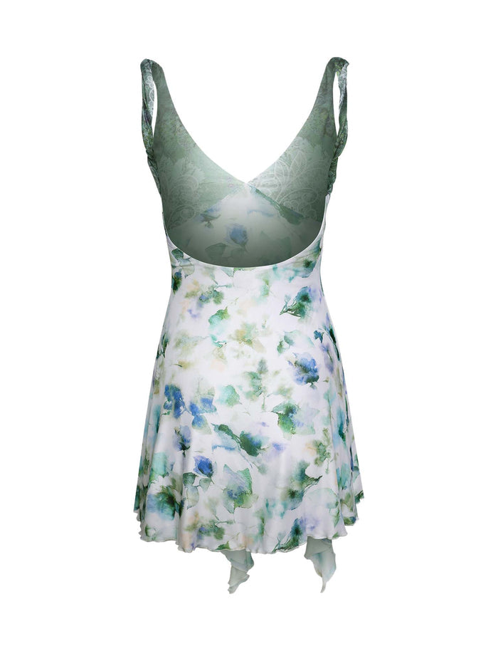 Introducing the THEO DRESS - GREEN : FLORAL by TIGERMIST, a stunning sleeveless dress featuring a V-neck and flared skirt. This mixed print masterpiece showcases watercolor-like flowers in vibrant green and blue. Complete with an asymmetrical hemline and a sophisticated semi-transparent upper back section, it exudes elegance.