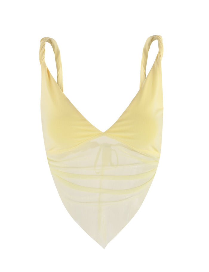 The Theo Top - Yellow : Lemon by Tigermist is showcased against a white background. This yellow v-neck crop top features a draped, triangular hem resembling a bandana and twisted shoulder straps. The fabric is light and slightly transparent, giving it a delicate and airy appearance.