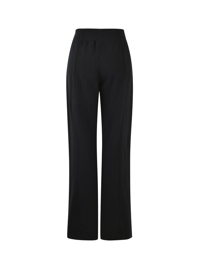 The VERDA PANT - BLACK from TIGERMIST is showcased against a plain white background. These high-waisted, wide-leg pants are crafted from smooth fabric and come with an elastic waistband.