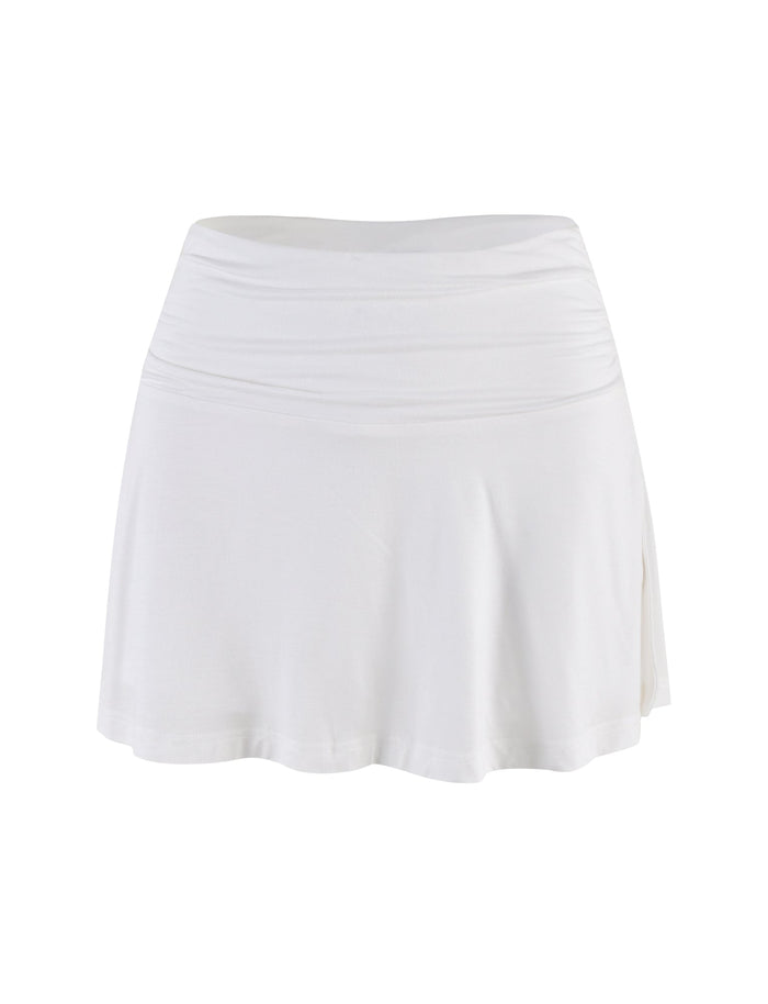 The VERITY SKORT - WHITE by TIGERMIST is a plain white, high-waisted A-line mini skort with a slightly flared hem, blending classic style with a sleek bodycon silhouette and displayed against a white background.