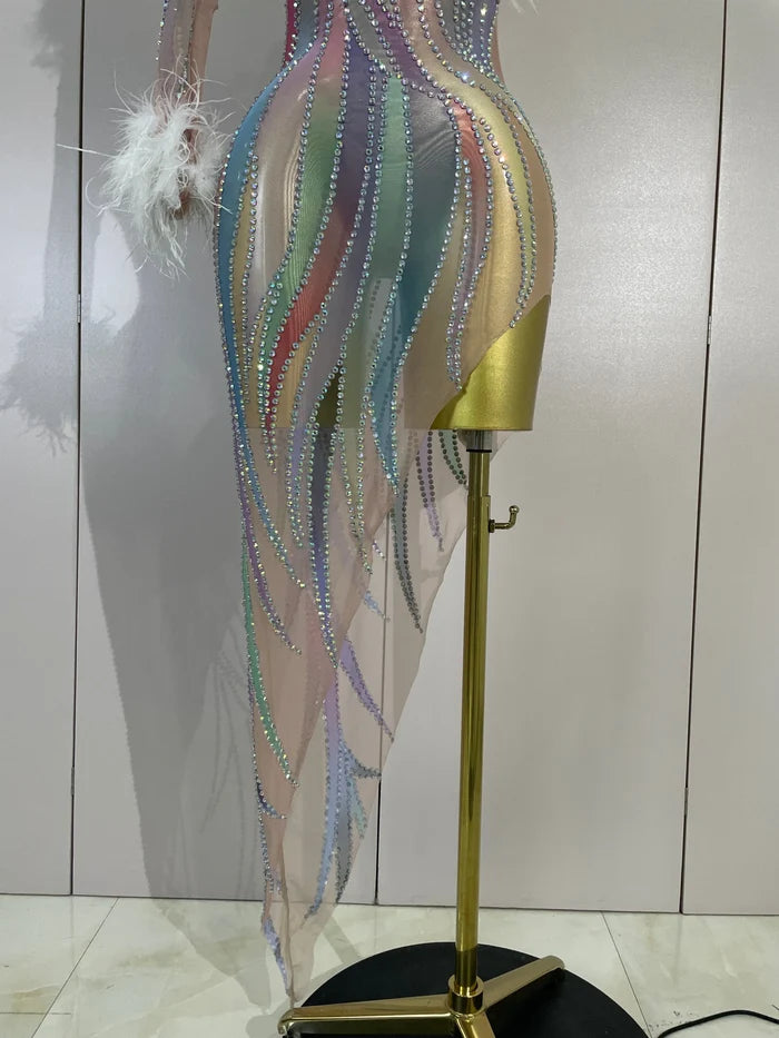 Turn heads in the Wendy one-shoulder rhinestone feather dress. Sexy sheer bodycon party dress for birthdays, cocktails, and evening events.