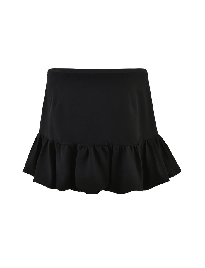 The XANDRA SKIRT – BLACK by TIGERMIST features a fitted waistline and a ruffled hem. The fabric is smooth and slightly stretchy, making for a chic and playful look. This skirt has a simple yet stylish design and is presented against a plain white background.