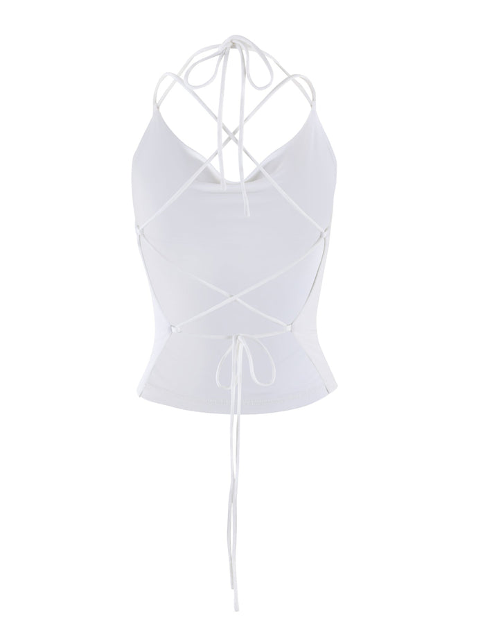 Introducing the ZAIDA TOP - WHITE from TIGERMIST, a stylish halter top featuring a fitted design and an intricate lace-up back. The crisscrossed strings tie at both the lower waist and neck, offering an open, adjustable fit. The smooth and stretchy fabric adds to its sophisticated look.