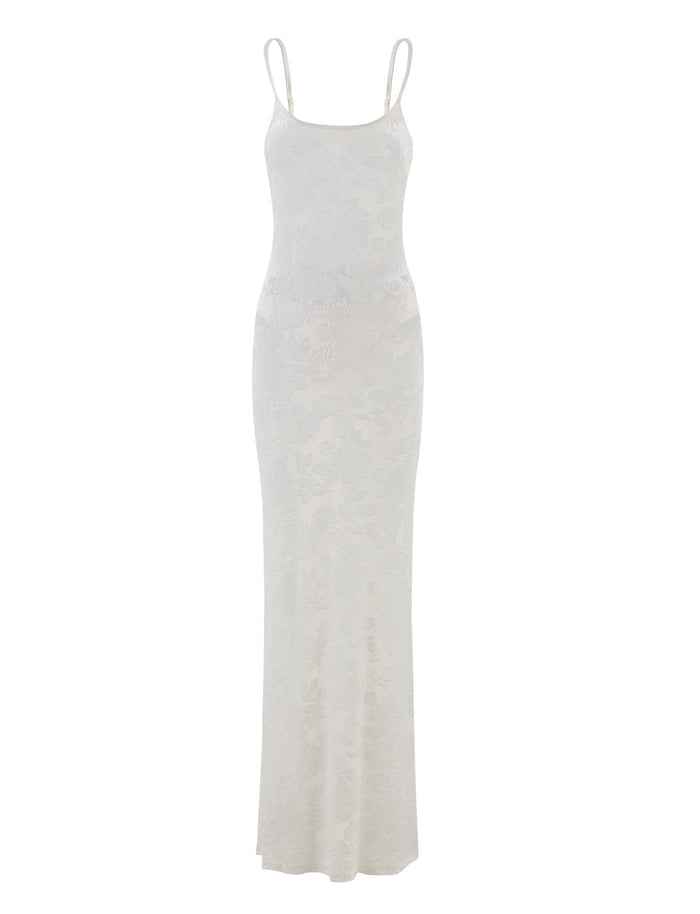 Here is a rewritten sentence using the provided product data:

The 'ZUZANNA DRESS - WHITE : BURN OUT : WHITE BURNOUT' by TIGERMIST is a long, fitted white dress with thin spaghetti straps and a subtle floral pattern. This design features a sleek, minimalist style and a floor-length hemline.
